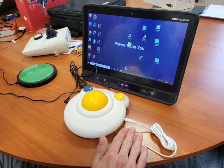 Na biurku stoi ekran i przyciski.