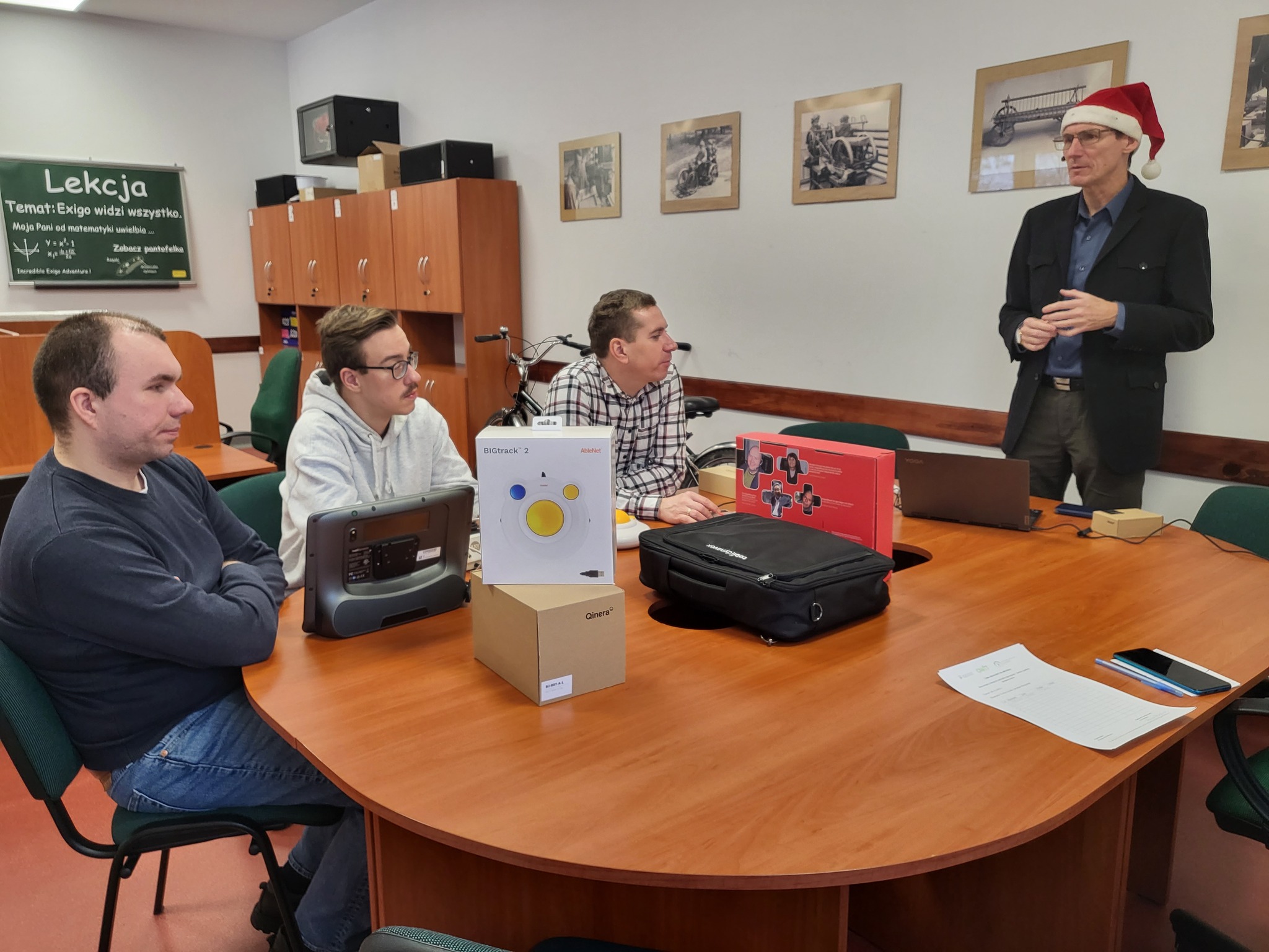 Pracownik w czapce św. Mikołaja opowiada o sprzętach.